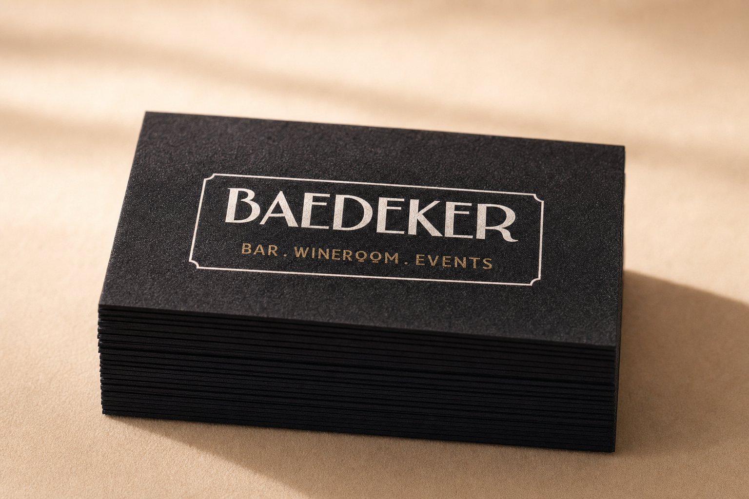 Tall stack of black velvet business cards showing thick 450gsm edges