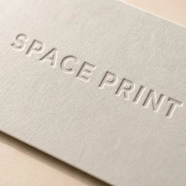 Debossed business card, logo pressed into white cotton stock