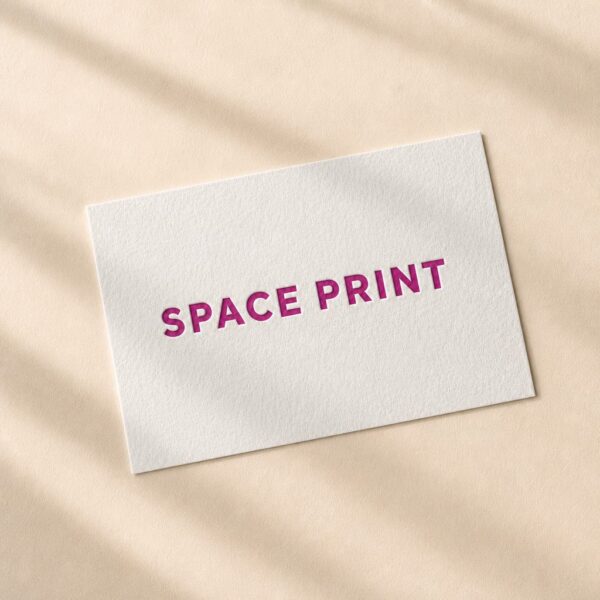 Letterpress business card, magenta ink pressed into white cotton stock