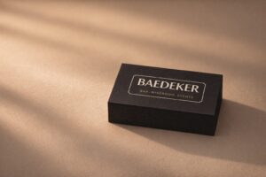 Stack of black velvet business cards with fine cut edges in warm light